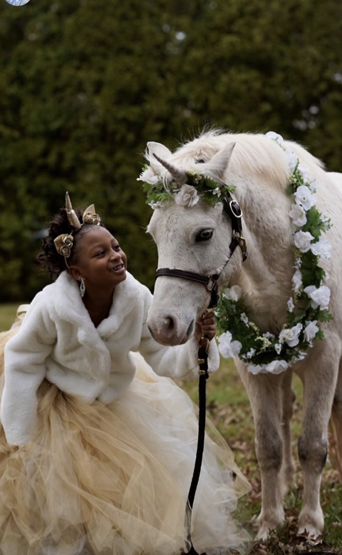 Little girl and unicorn bonding